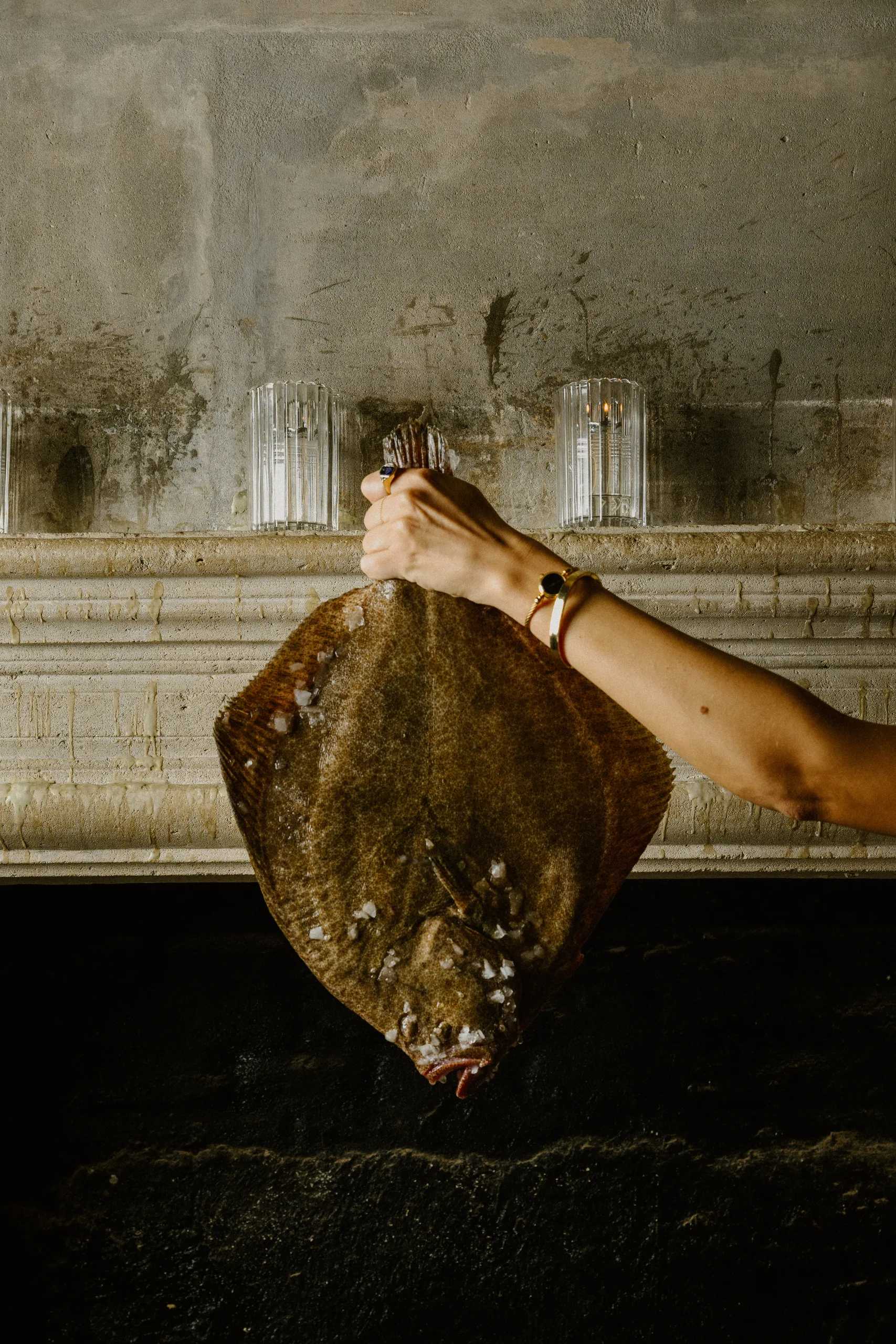 Salt-crusted flatfish held at the fireplace at Boca Grande Barcelona